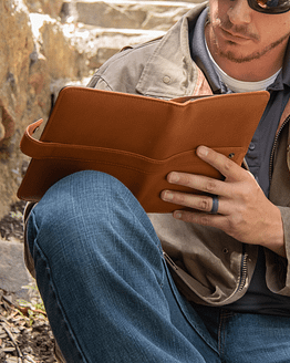 Man writes in Escriba small leather journal