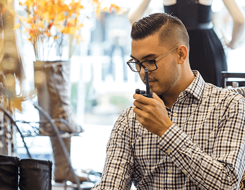 Retail sales clerk talking on a Motorola two way radio