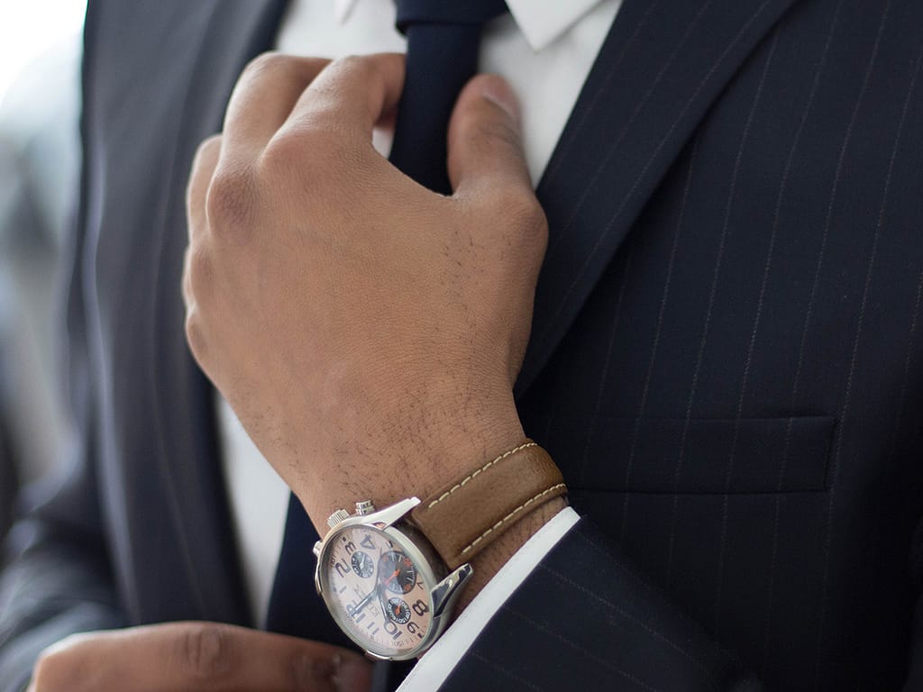 image of watch on arm of man in suit