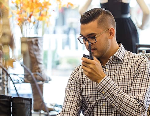 Retail sales clerk talking on a Motorola two way radio