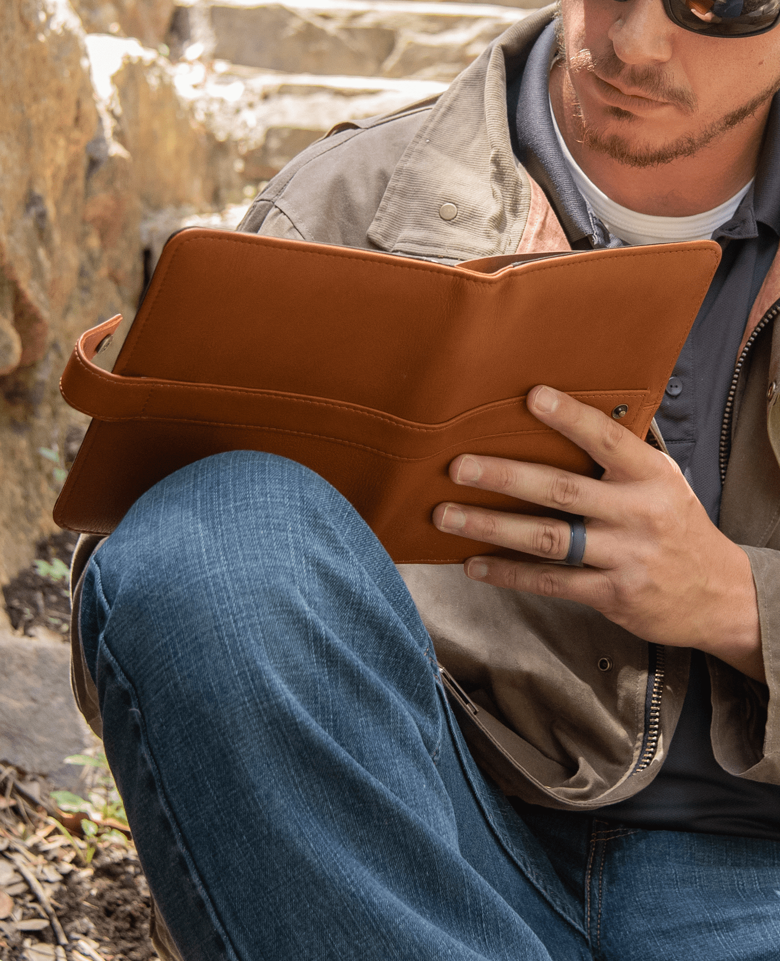 Man writes in Escriba small leather journal