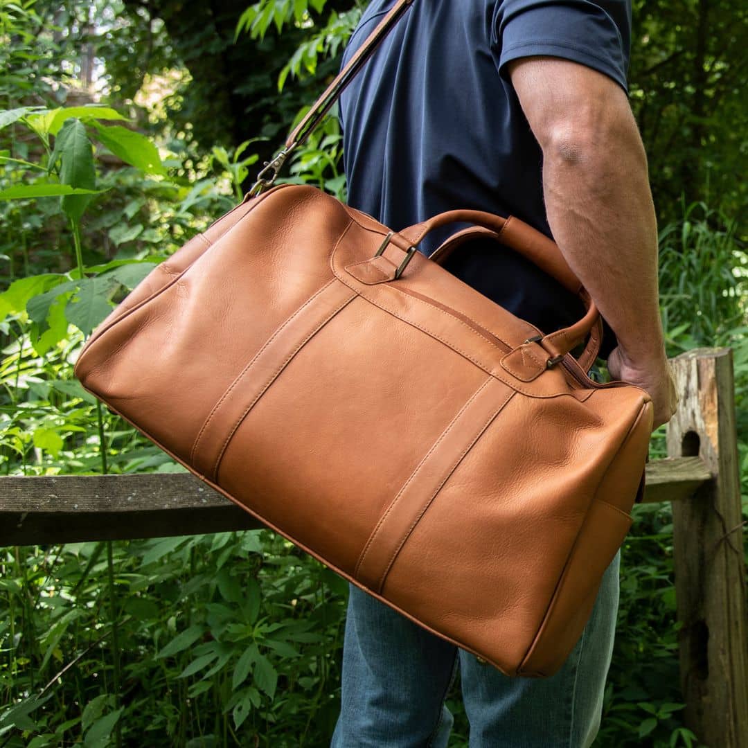 Man with large leather duffel bag